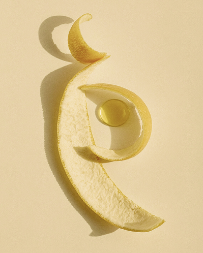 Close-up of a pale cream textured curl against a cream background